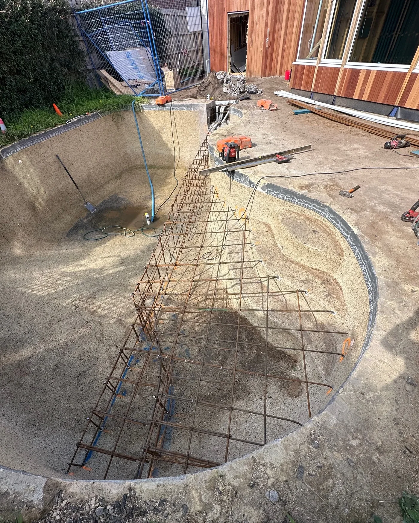 Whole curved pool renovation showing new steel reinforcement shaped through the existing shell.