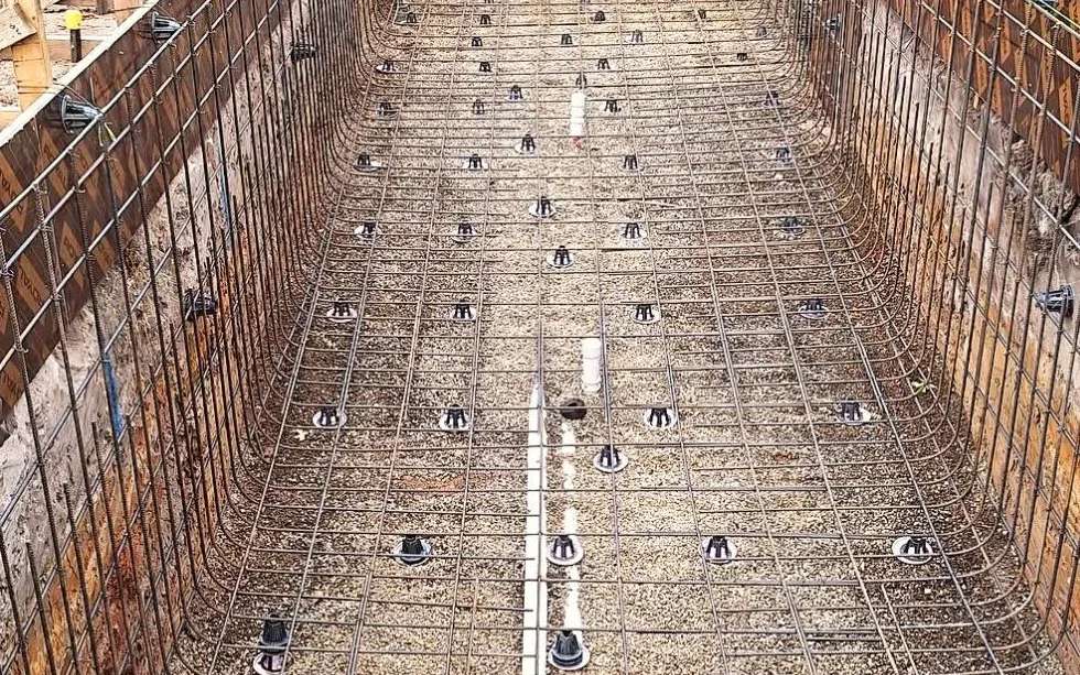Reinforcement cage and in-shell plumbing prepared inside a formed concrete pool structure in Camberwell.